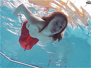 crimson clothed teenager swimming with her eyes opened