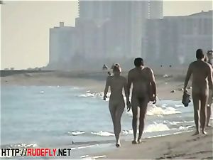 peeping at a red-hot nudist couple on the beach